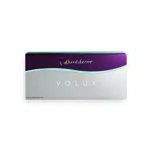 Image of a white and purple box with the brand name "JUVÉDERM®" and the product name "VOLUX® with Lidocaine" written on it. The box contains 2 x 1 ml injectable gel syringes. The design includes a purple and teal wavy line across the top.