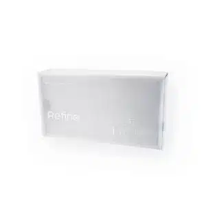 A rectangular white box with minimalistic design and subtle text. The text on the box reads "REFINE + ULTRA SOFT" and "1ml". The packaging has a sleek, modern appearance with a clear sense of simplicity and elegance.