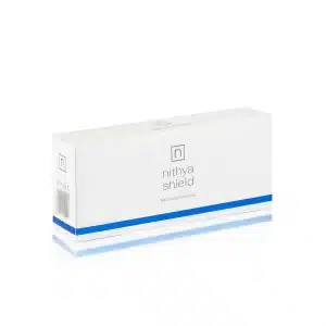 A rectangular white box with a blue stripe at the bottom is shown. The box is labeled "NITHYA SHIELD" with the tagline "Natural protection" below it. The minimalist design features a small gray "n" logo near the top center of the box.