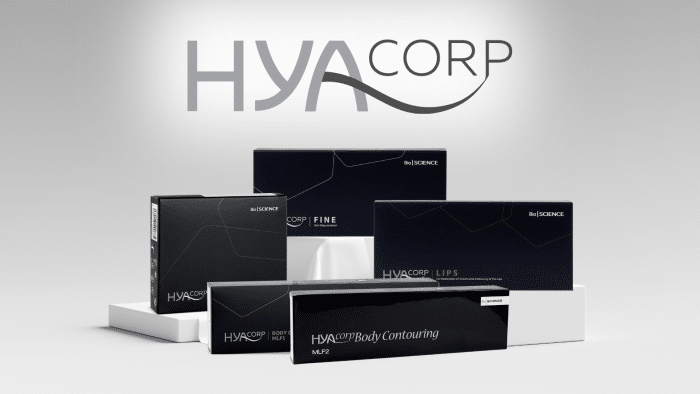 A collection of black and white product boxes labeled with "HYACORP" and "Bio SCIENCE" displayed on a white surface. The largest box at the front reads "HYACORP Body Contouring," with other smaller boxes labeled "Fine" and "Lips." Known for their safety, these hyacorp fillers feature the brand logo above.