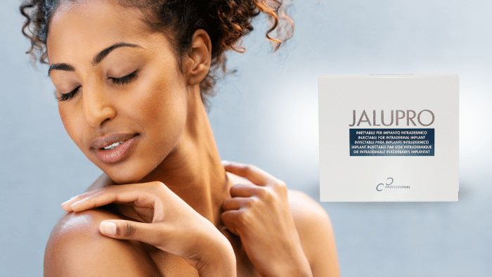 A woman with curly hair softly touches her shoulder, eyes closed, appearing relaxed and serene. Next to her is a box labeled "JALUPRO" against a soft gradient background, suggesting longevity as people often wonder, "Jalupro - how long does it last?" The packaging features additional text in multiple languages.