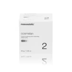 A white, cubic box of "MESOESTETIC® COSMELAN® 2" cream is pictured. The text on the box indicates it is for reducing and/or eliminating melanic spots. The net weight is 30 grams or 1.06 ounces. The design features minimalist grey and black text and small dots.