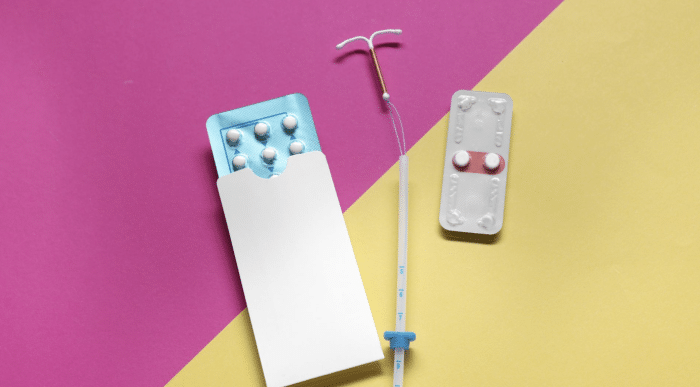 A collage of contraceptive methods on a two-tone pink and yellow background, including a box of white pills in blue packaging, a white blister pack with two red pills, and an intrauterine device (IUD) with an inserter.