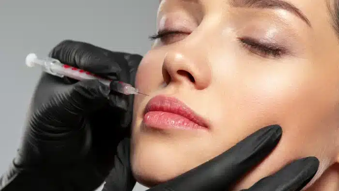Woman getting a facial injection.