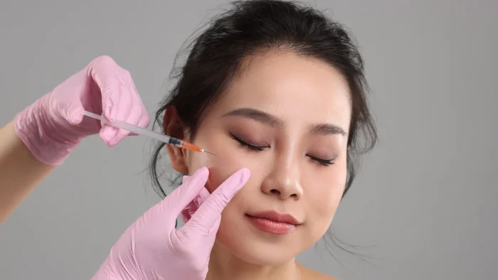 Woman getting facial injection.