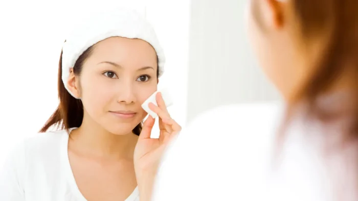 Woman cleaning her face.