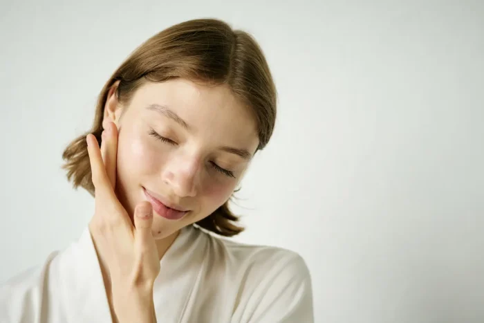 Woman touching her face.