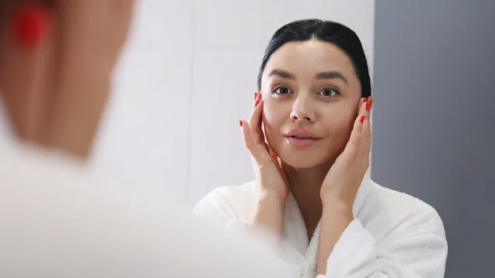 Woman looking into the mirror.